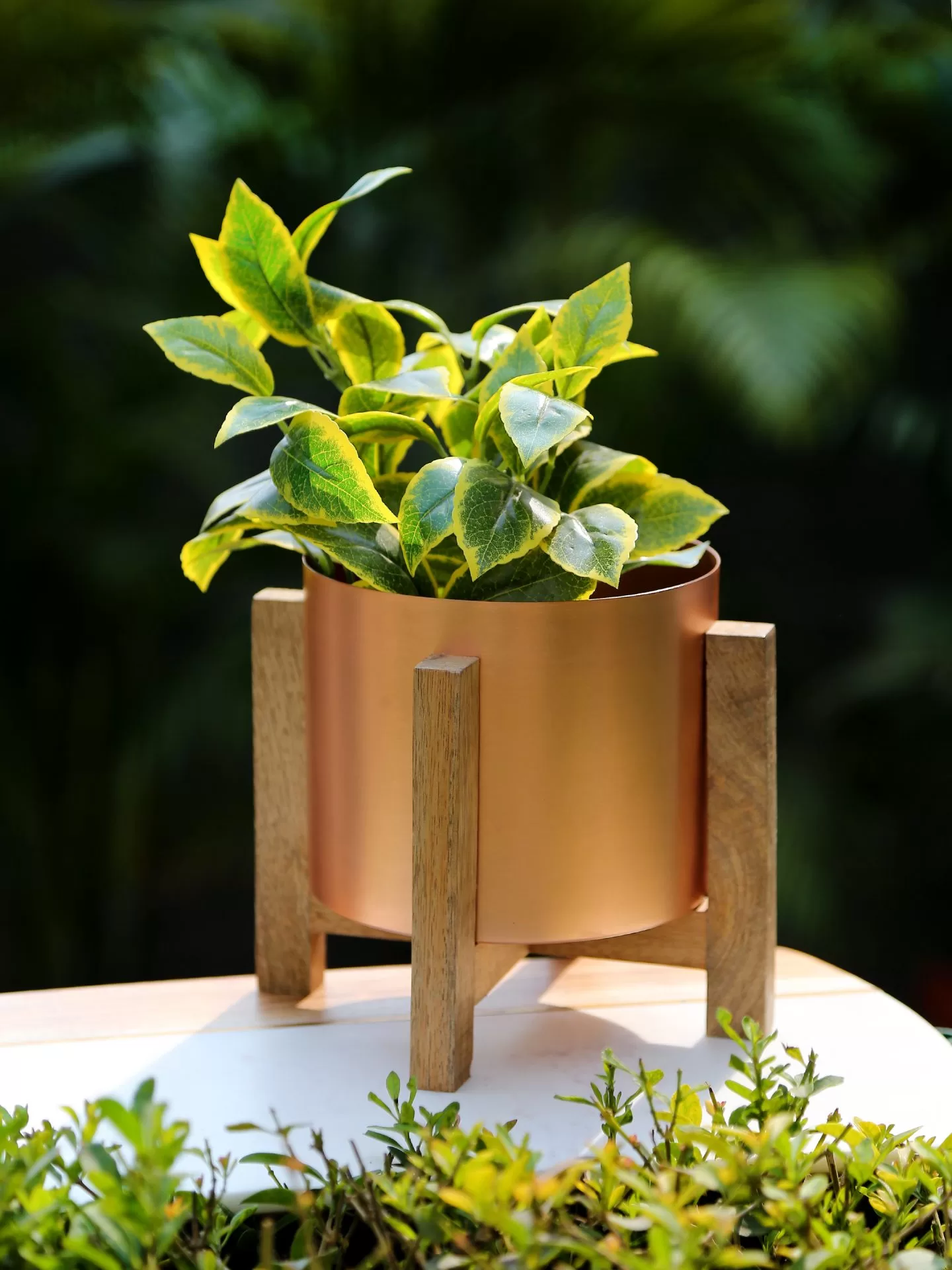 Copper look planter on wooden stand – Amoliconcepts